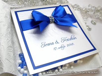 white greeting card with blue ribbon