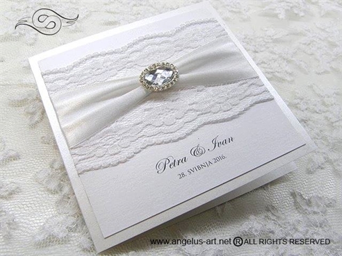 wedding invitation with white lace and brooch
